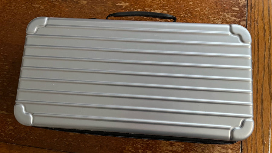 I'm extremely satisfied with this keyboard organizer. The small item compartment has a zipper, and the dust cover in the middle can move up and down easily. The ability to secure the keyboard with Velcro is also a plus.